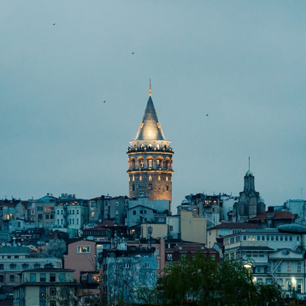 a very tall clock tower towering over a city