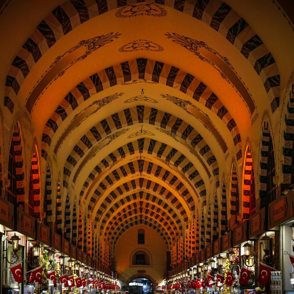 Explore the beautifully illuminated archway interior of Istanbul's famous Grand Bazaar, Türkiye.