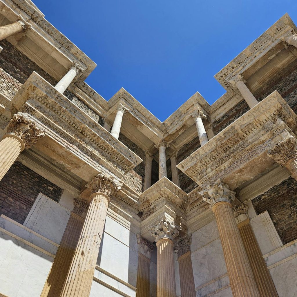 Majestic Roman architectural columns in Sardis, Manisa, Türkiye under clear blue sky.