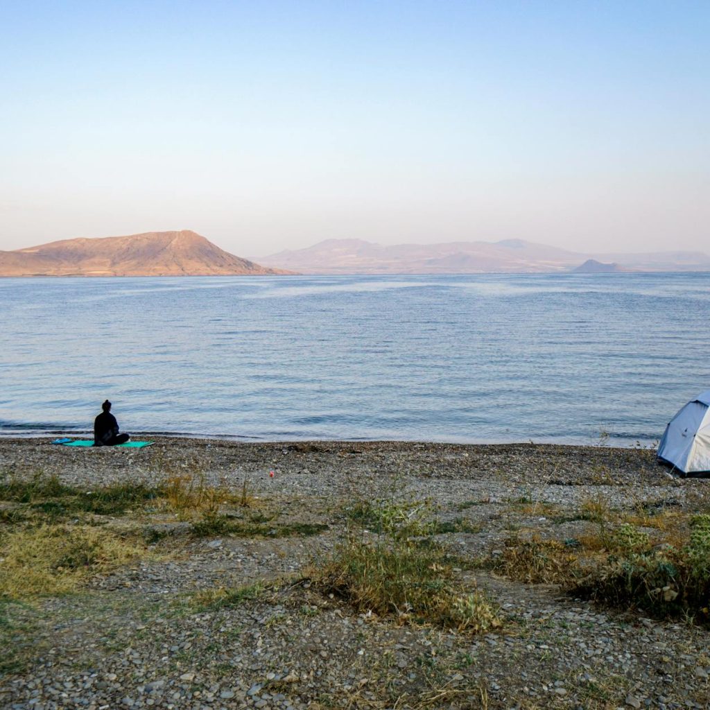 Peaceful camping scene on the beach by Lake Van in Turkey, showcasing nature's tranquility.