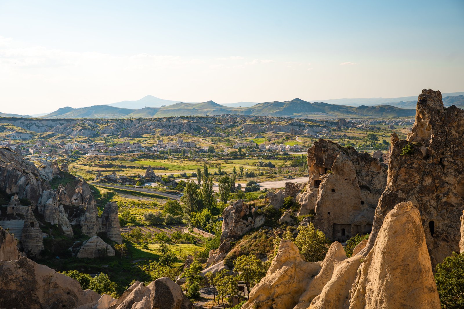 A breathtaking view of Cappadocia's iconic rock formations under a clear sky in Nevşehir, Türkiye