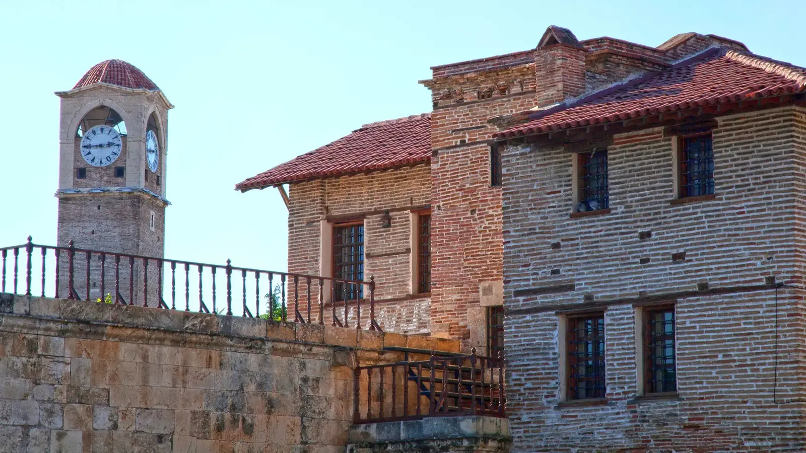 Clock tower and old brick houses in central Adana