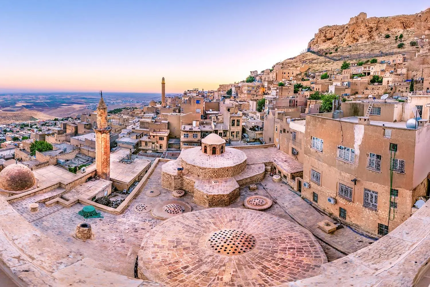 Domes and flat stone roofs of Mardin's old town above the Mesopotamian plain