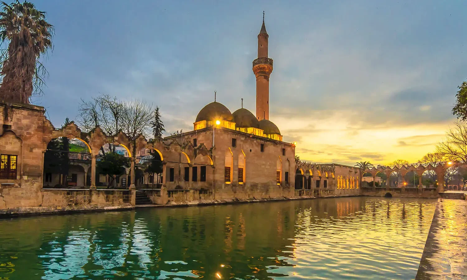 The Halil-ür Rahman Mosque on the edge of the sacred pool at sunset