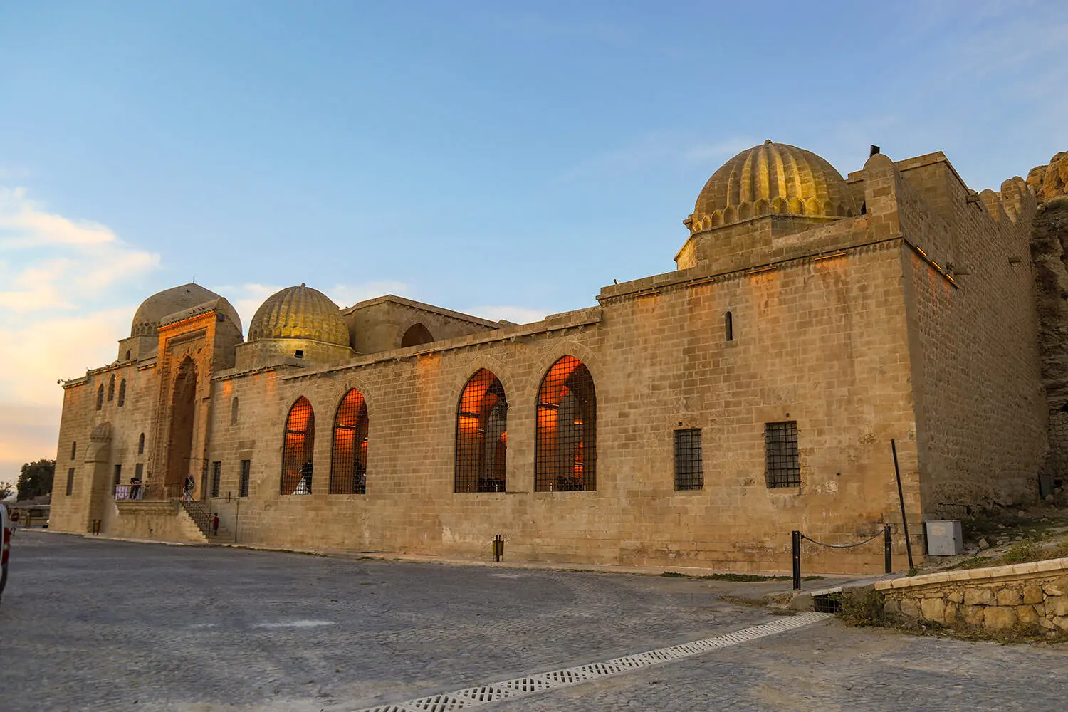 The long façade and domes of the Kasımiye Madrasa at sunset