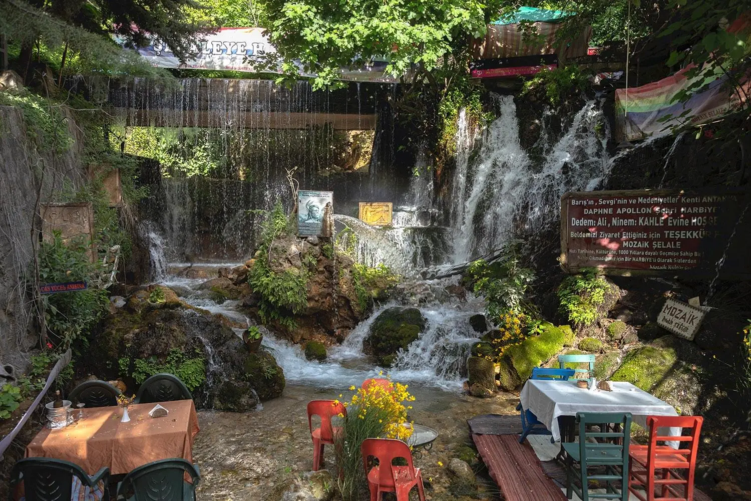 Restaurant tables beside the falls at Harbiye