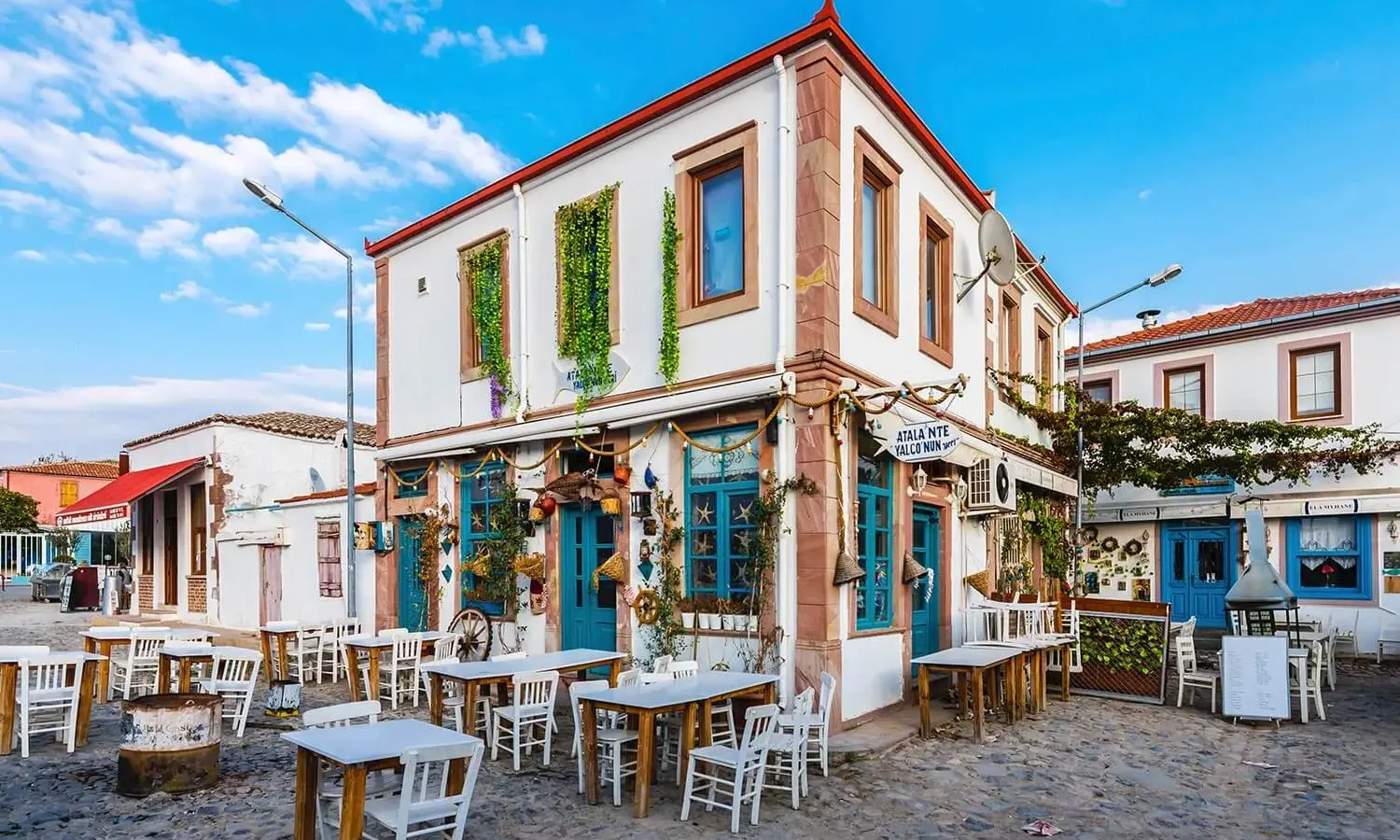 A restored stone house on a Cunda square